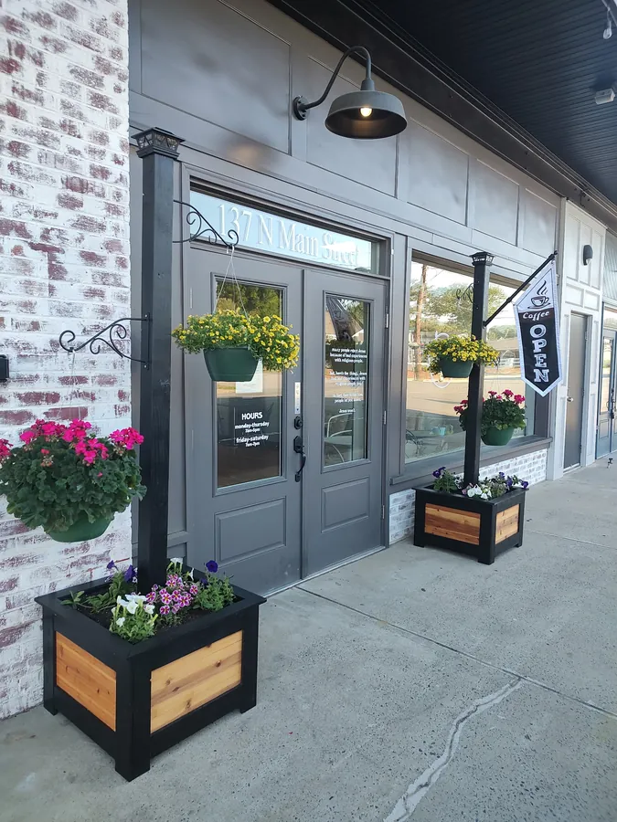 Wooden post-mounted hanging planters built for outdoor use
