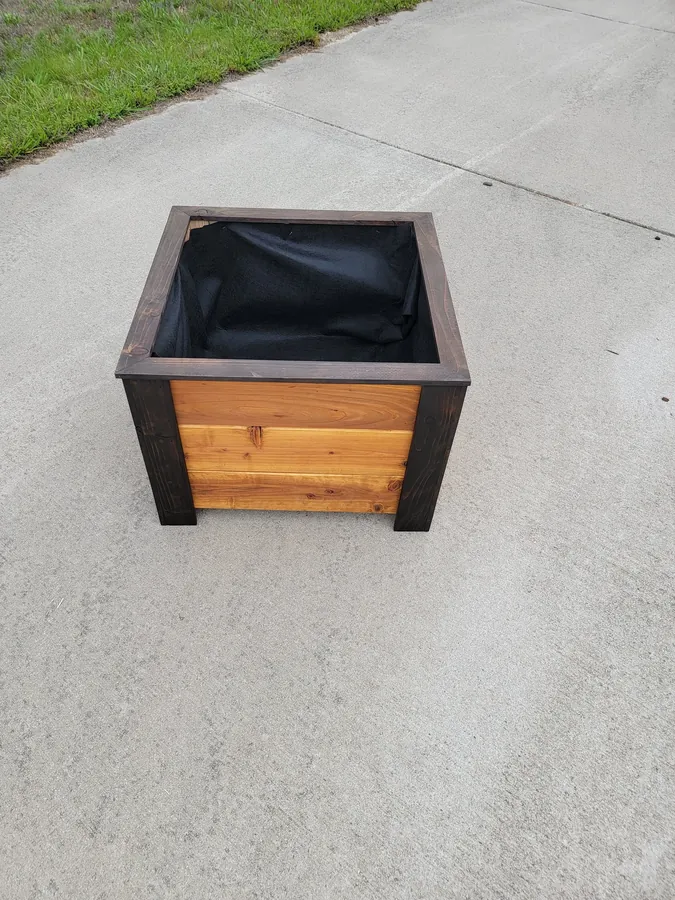 Outdoor wooden planter and display piece with black trim